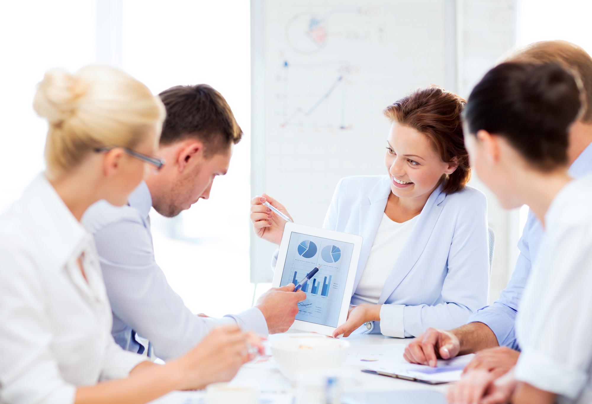Workshop participants discussing finances in a modern workspace